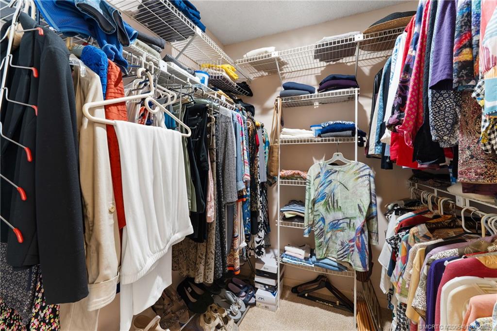 2437 Southwest Foxpoint Trail Palm City, FL 34990 - Photo 22 of 60 a view of walk in closet with clothes
