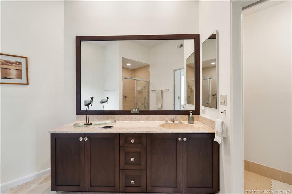 2437 Southwest Foxpoint Trail Palm City, FL 34990 - Photo 24 of 60 a bathroom with a sink and a mirror