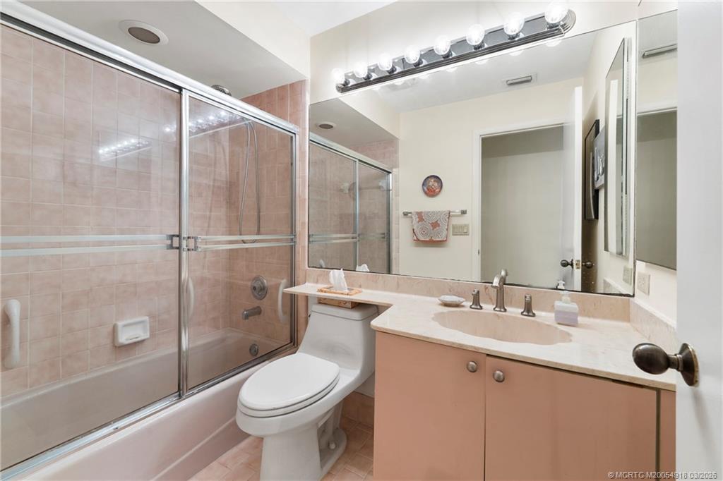 2437 Southwest Foxpoint Trail Palm City, FL 34990 - Photo 28 of 60 a bathroom with a sink toilet and shower