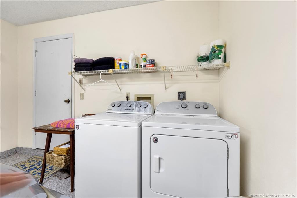 2437 Southwest Foxpoint Trail Palm City, FL 34990 - Photo 31 of 60 a view of storage and utility room with washer and dryer