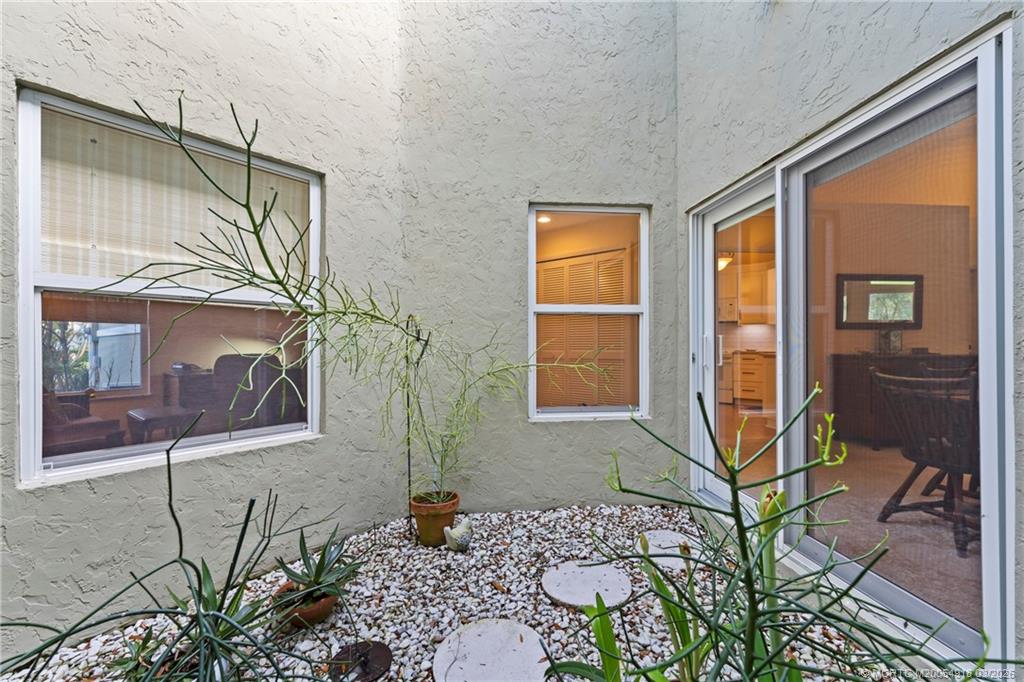 2437 Southwest Foxpoint Trail Palm City, FL 34990 - Photo 32 of 60 a house with a glass door