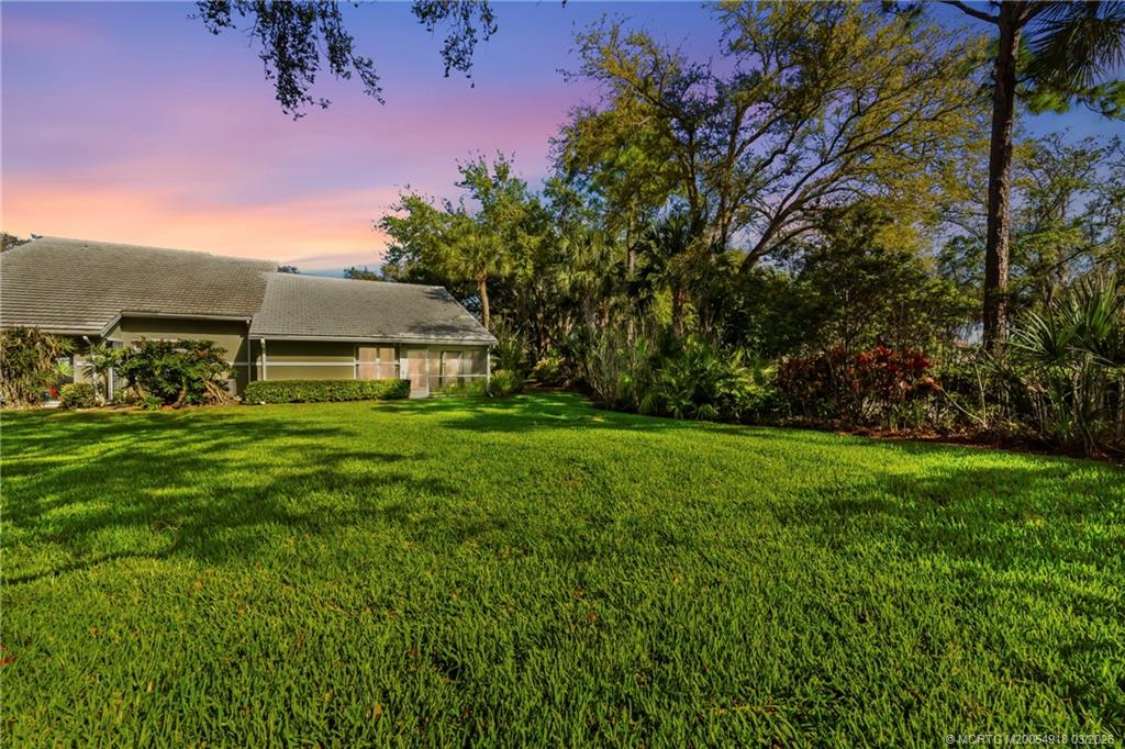 2437 Southwest Foxpoint Trail Palm City, FL 34990 - Photo 36 of 60 a view of an house with backyard space and garden