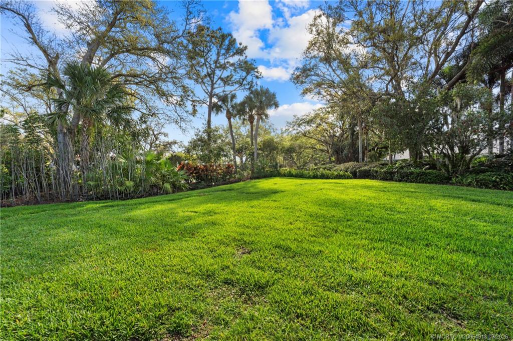 2437 Southwest Foxpoint Trail Palm City, FL 34990 - Photo 37 of 60 a view of a grassy field with trees