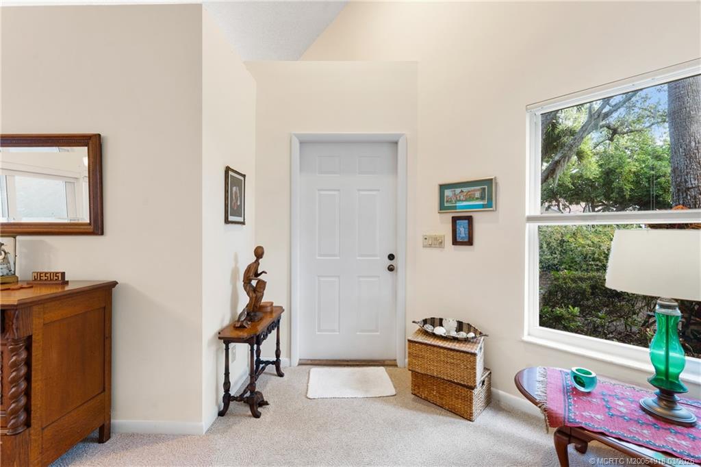2437 Southwest Foxpoint Trail Palm City, FL 34990 - Photo 4 of 60 a room with furniture and a window