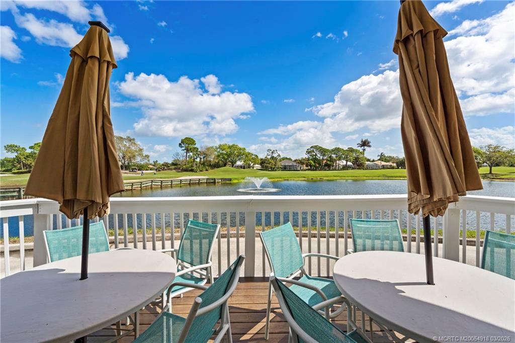 2437 Southwest Foxpoint Trail Palm City, FL 34990 - Photo 55 of 60 a view of a patio with a table chairs and a table