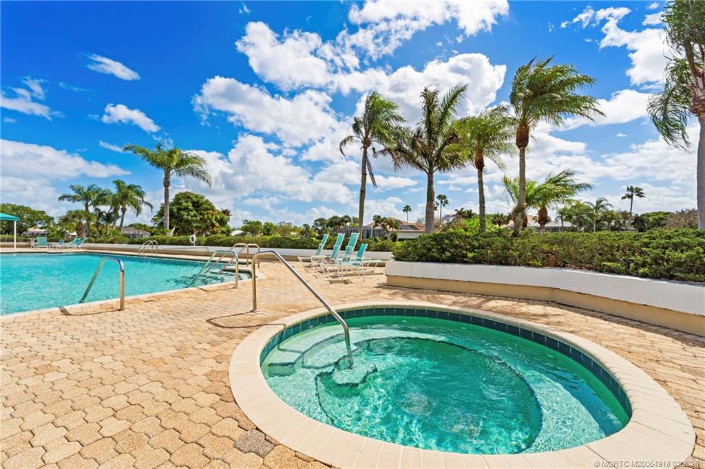 2437 Southwest Foxpoint Trail Palm City, FL 34990 - Photo 58 of 60 a swimming pool with outdoor seating and garden