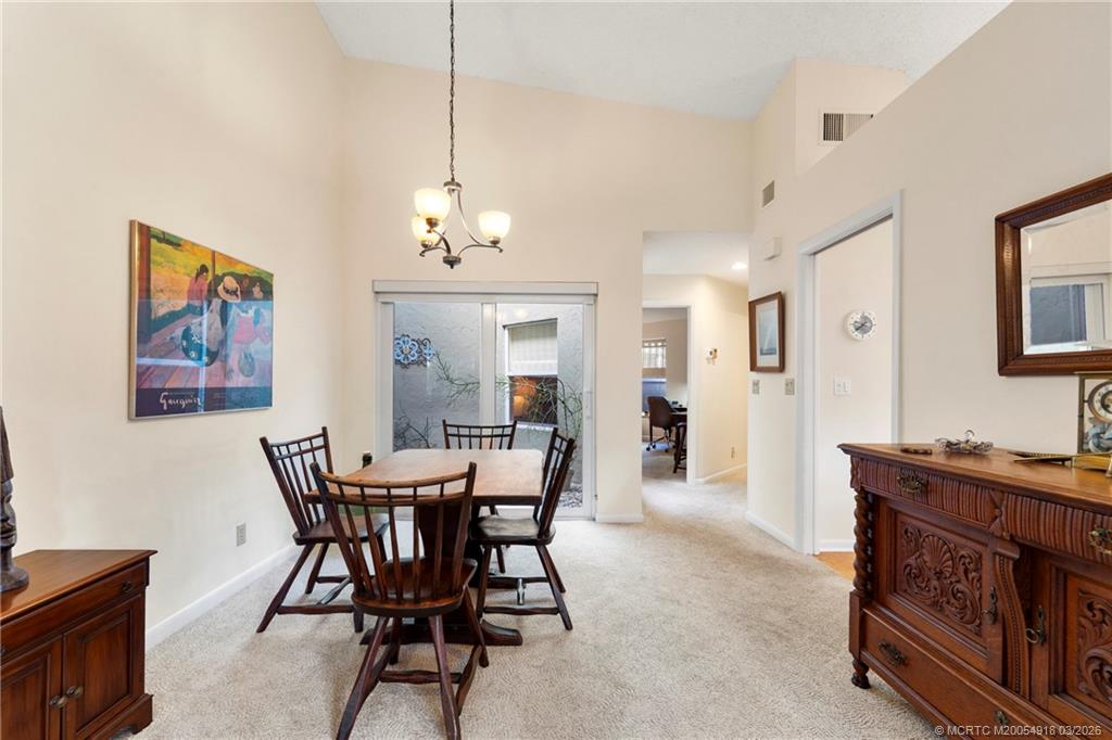 2437 Southwest Foxpoint Trail Palm City, FL 34990 - Photo 10 of 60 a view of a dining room with furniture and a chandelier