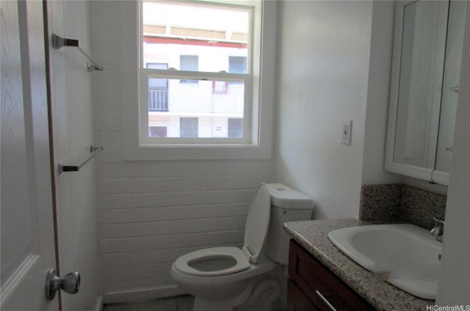 1449 Punchbowl Street Honolulu, HI 96813 - Photo 14 of 18 a bathroom with a granite countertop toilet and a sink