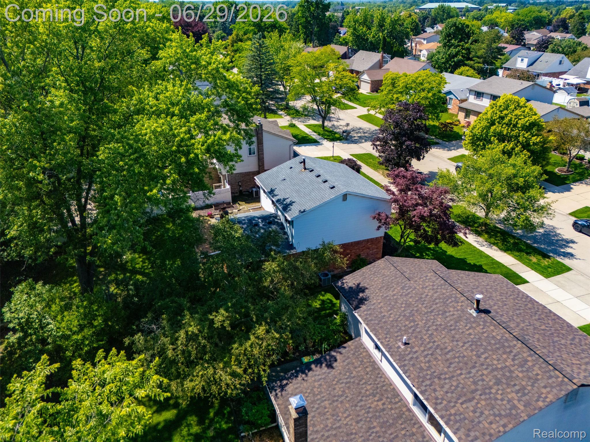 45179 Rudgate Road Canton, MI 48188 - Photo 47 of 48 Residential property featuring a brown asphalt shingle roof, white siding, and partial brick exterior