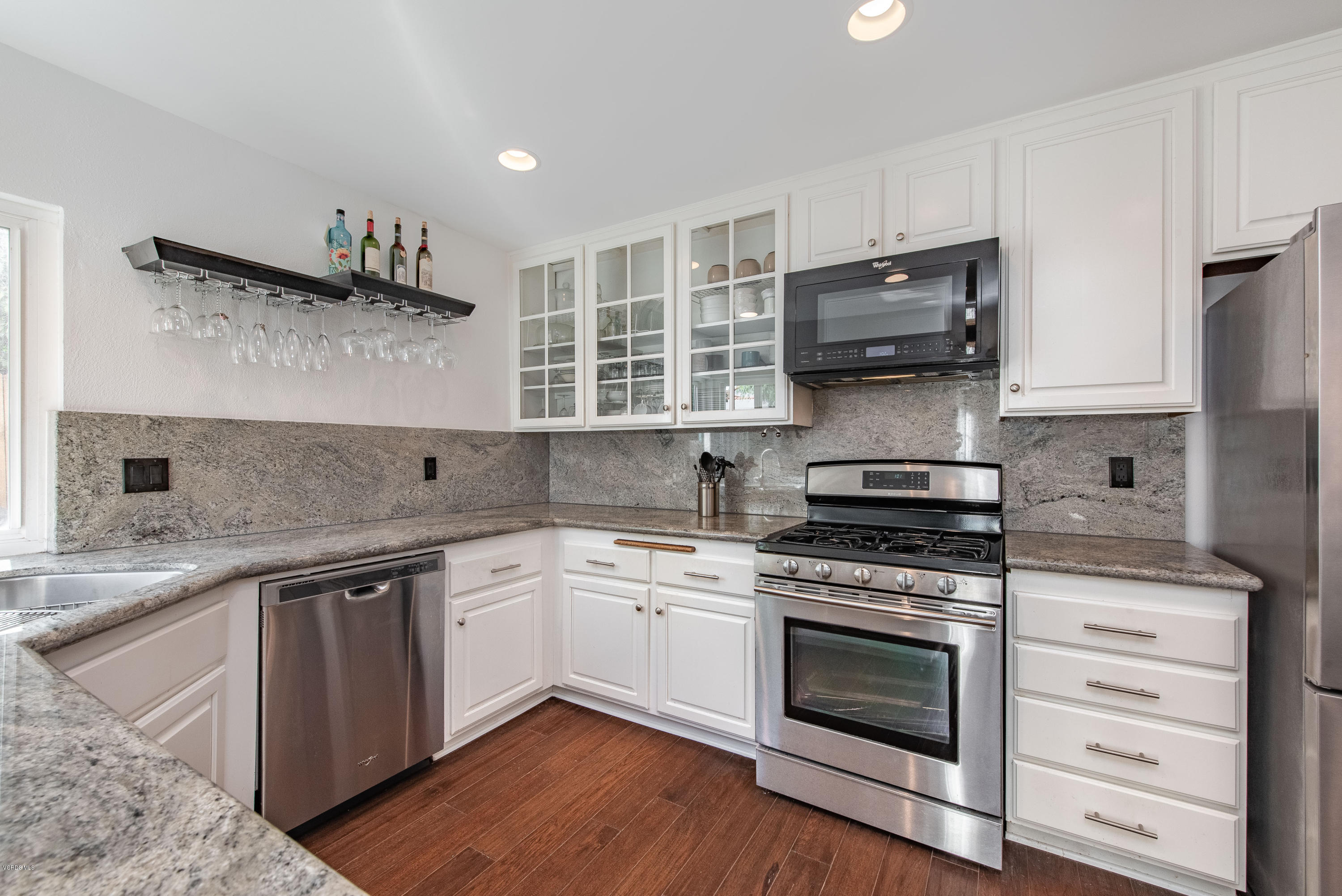 15430 Kernvale Avenue Moorpark, CA 93021 - Photo 1 of 16 a kitchen with stainless steel appliances white cabinets and a sink