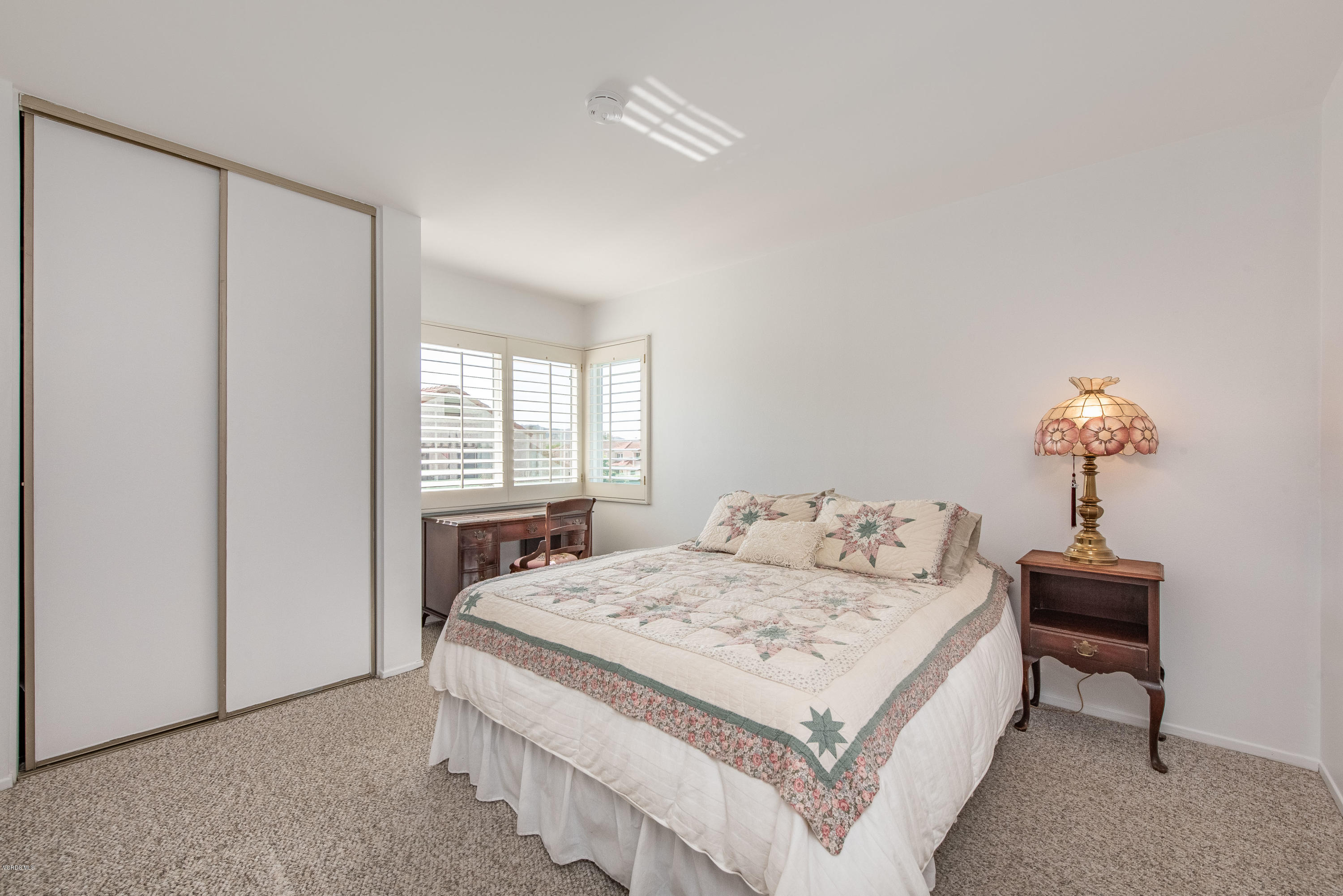 15430 Kernvale Avenue Moorpark, CA 93021 - Photo 12 of 16 a bedroom with a bed and a window