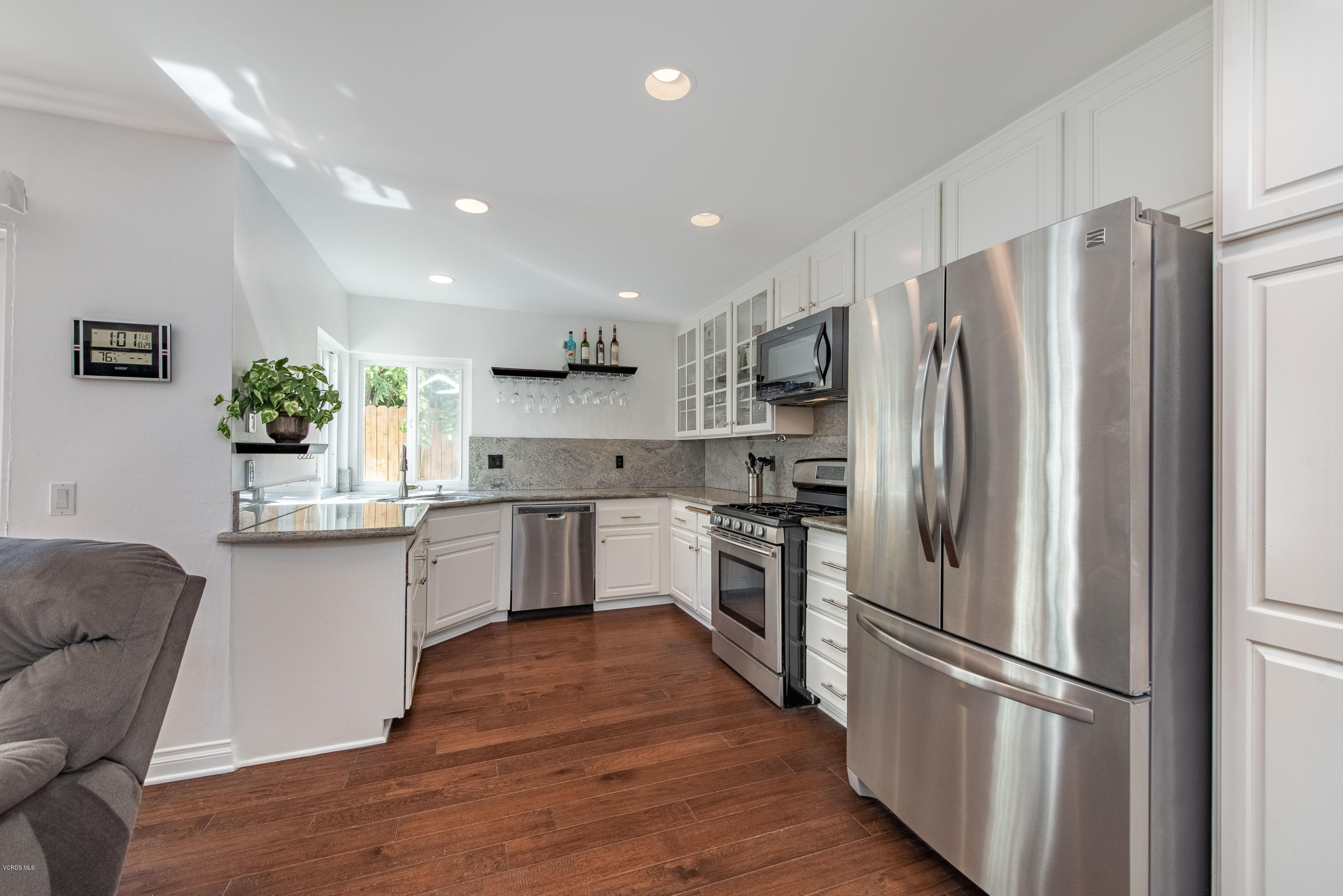 15430 Kernvale Avenue Moorpark, CA 93021 - Photo 6 of 16 a kitchen with a refrigerator cabinets stainless steel appliances and a window