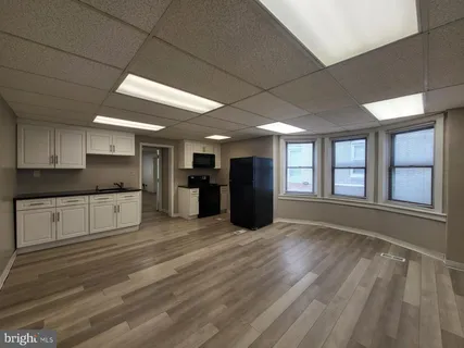 a large kitchen with stainless steel appliances granite countertop a large stove a refrigerator a sink and dishwasher with wooden floor