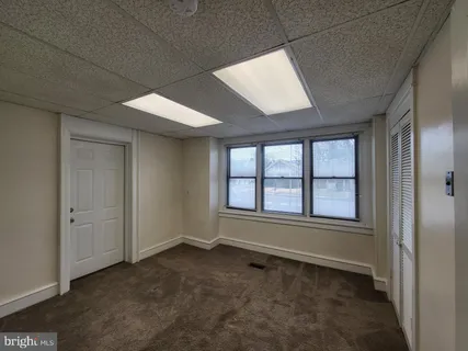 an empty room with a empty space and windows