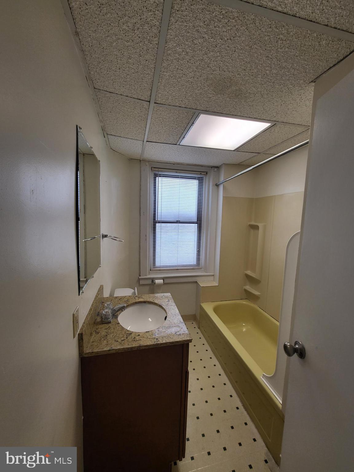 2114 Darby Road Havertown, PA 19083 - Photo 10 of 10 a bathroom with a granite countertop sink a mirror and a bathtub