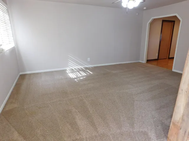 a kitchen with kitchen island granite countertop wooden cabinets a refrigerator stove a sink and dishwasher