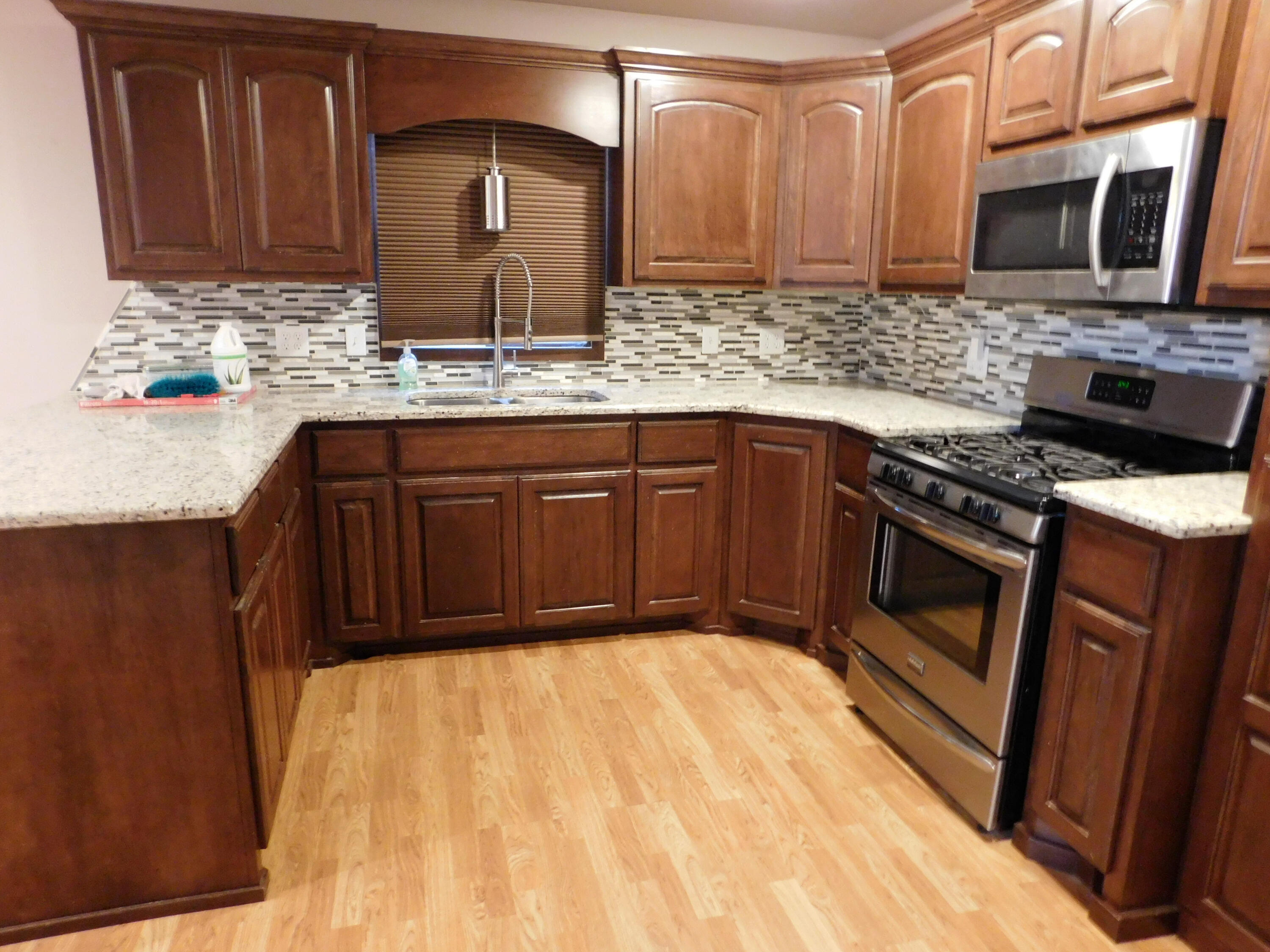 1722 West Ave B Muleshoe, TX 79347 - Photo 7 of 20 a kitchen with stainless steel appliances granite countertop wooden cabinets a oven and granite counter tops