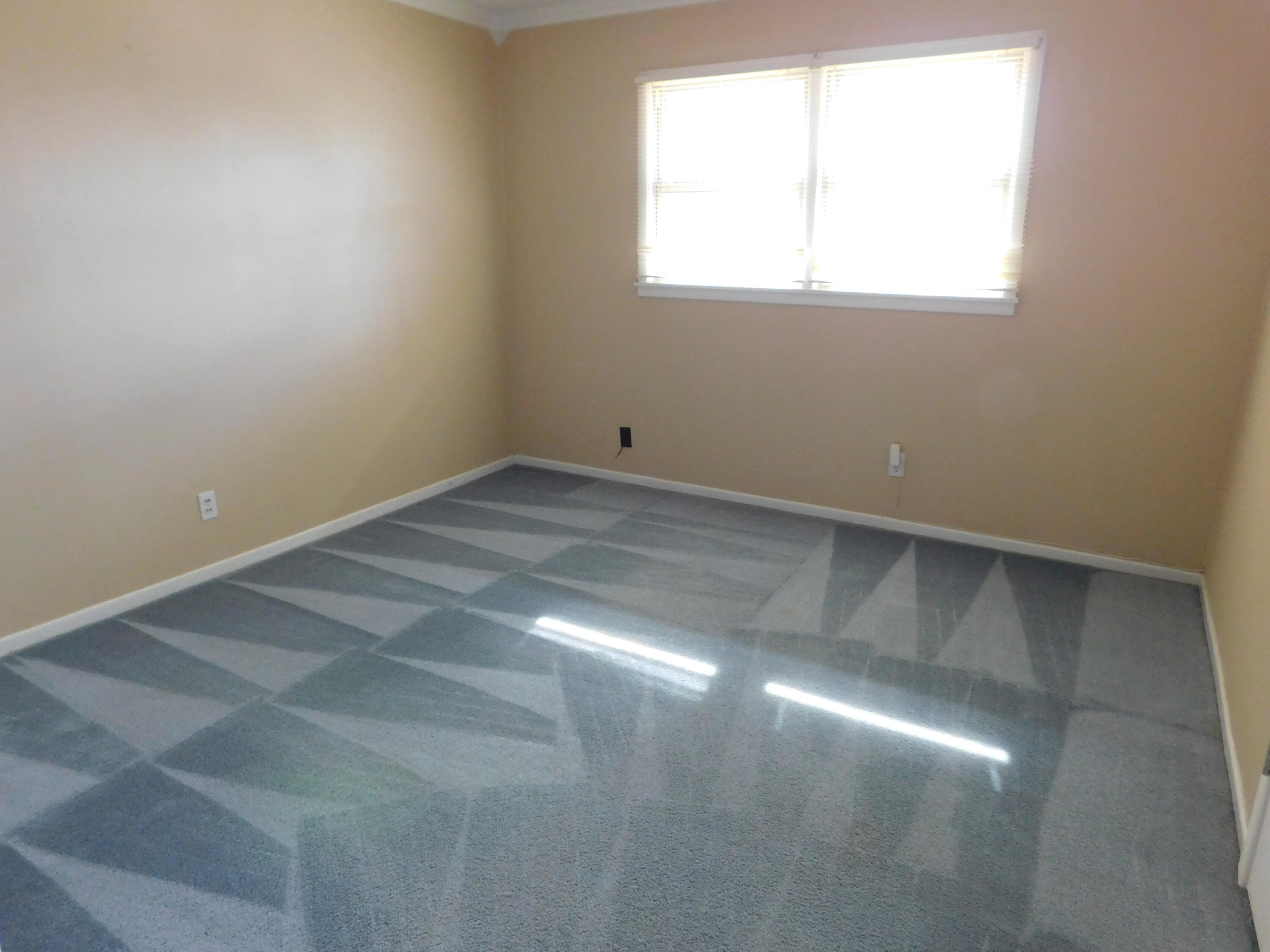 1722 West Ave B Muleshoe, TX 79347 - Photo 9 of 20 an empty room with a window