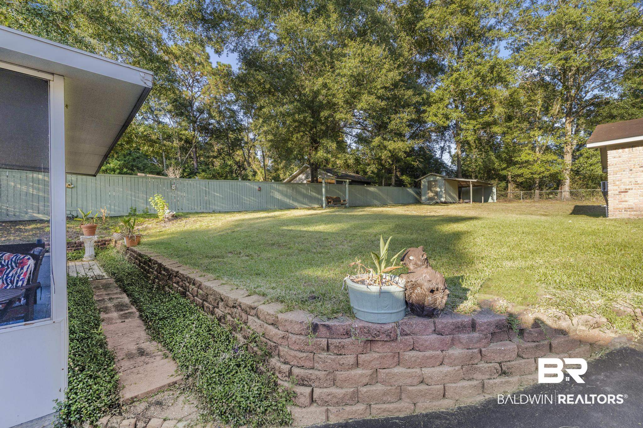 2573 E Road Mobile, AL 36693 - Photo 31 of 45 Fenced backyard featuring an outbuilding