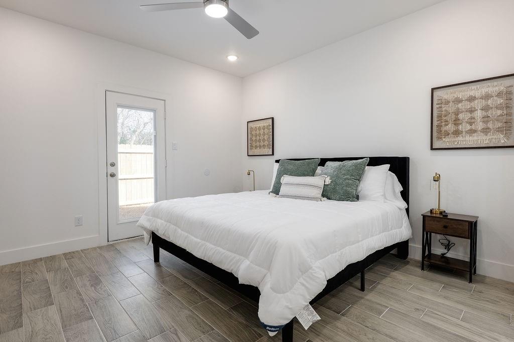 709 Fuller Street Sulphur Springs, TX 75482 - Photo 13 of 22 a bedroom with a bed and wooden floor