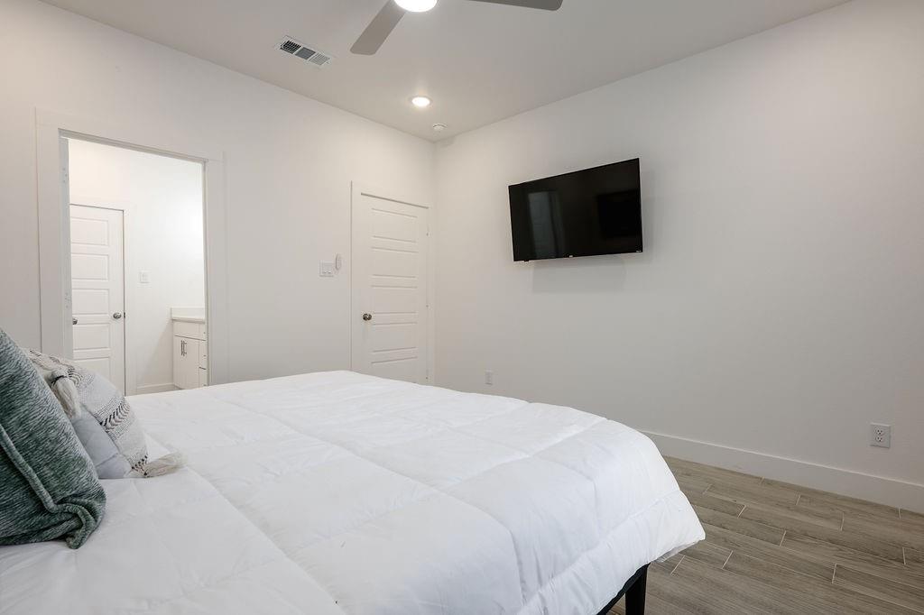 709 Fuller Street Sulphur Springs, TX 75482 - Photo 14 of 22 a bedroom with a bed and a flat screen tv