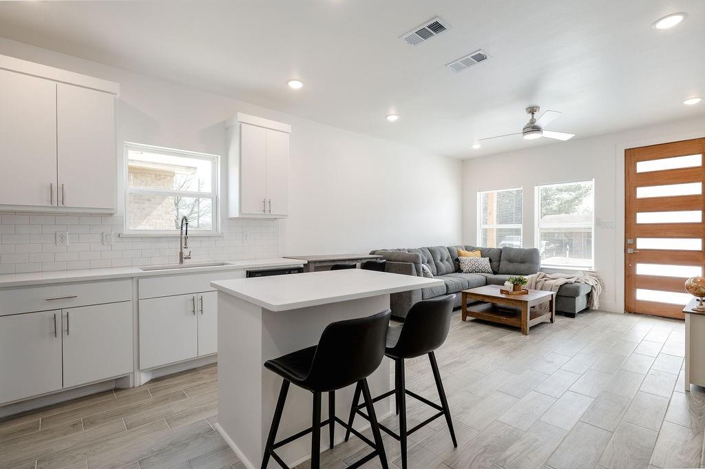 709 Fuller Street Sulphur Springs, TX 75482 - Photo 8 of 22 a kitchen with a sink cabinets and window