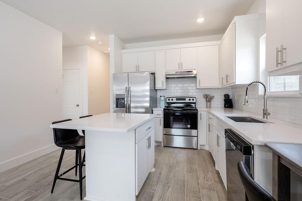 709 Fuller Street Sulphur Springs, TX 75482 - Photo 10 of 22 a kitchen with stainless steel appliances a stove a sink and a refrigerator