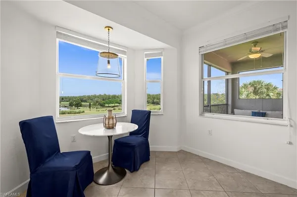 a view of a bathroom with a sink mirror and window