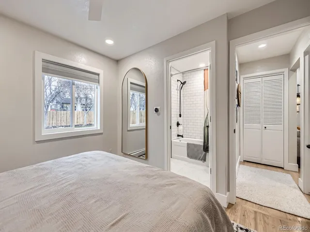a bedroom with a bed and a painting on the wall