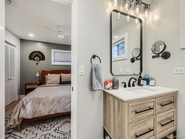 a bedroom with a bed and a mirror