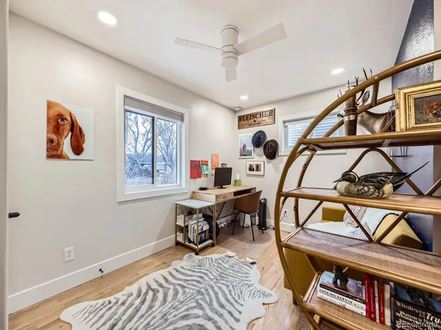a living room with furniture a rug and a window