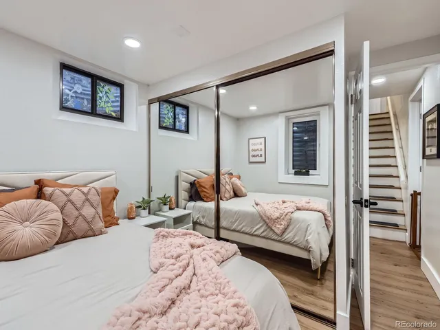 a bedroom with furniture and a wooden floor