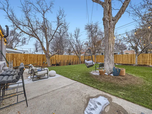 a view of a backyard with table and chairs and a slide