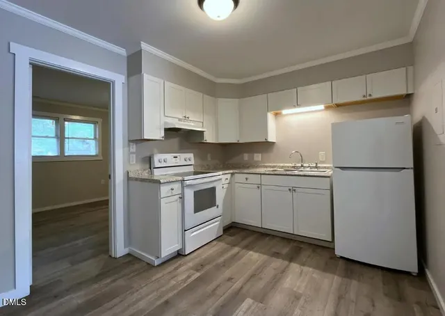 a kitchen with stainless steel appliances a refrigerator sink and cabinets