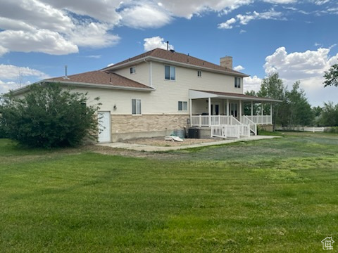 190 600 North Ferron, UT 84523 - Photo 72 of 85 Rear view of house with a chimney, a yard, and covered porch