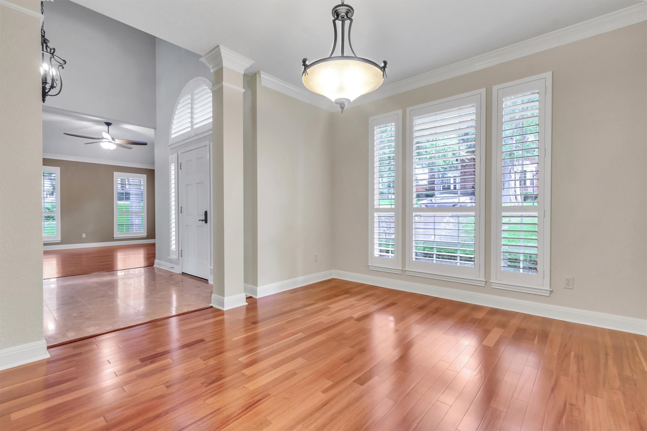 6008 Tributary Ridge Court Austin, TX 78759 - Photo 5 of 36 Natural light bathes rich hardwood flooring, extending from a gracious entryway into this inviting dining room /entertaining area.