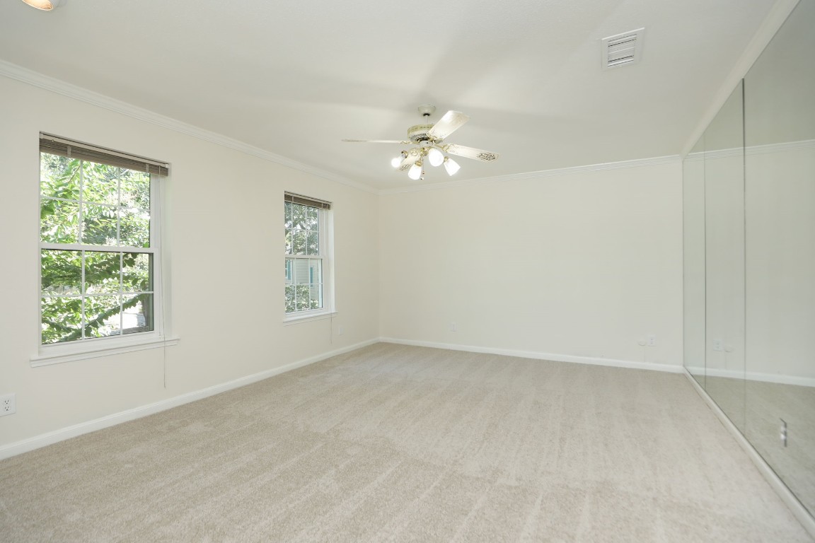 7499 Brompton Street, Unit 7499 Houston, TX 77025 - Photo 26 of 43 an empty room with windows and fan