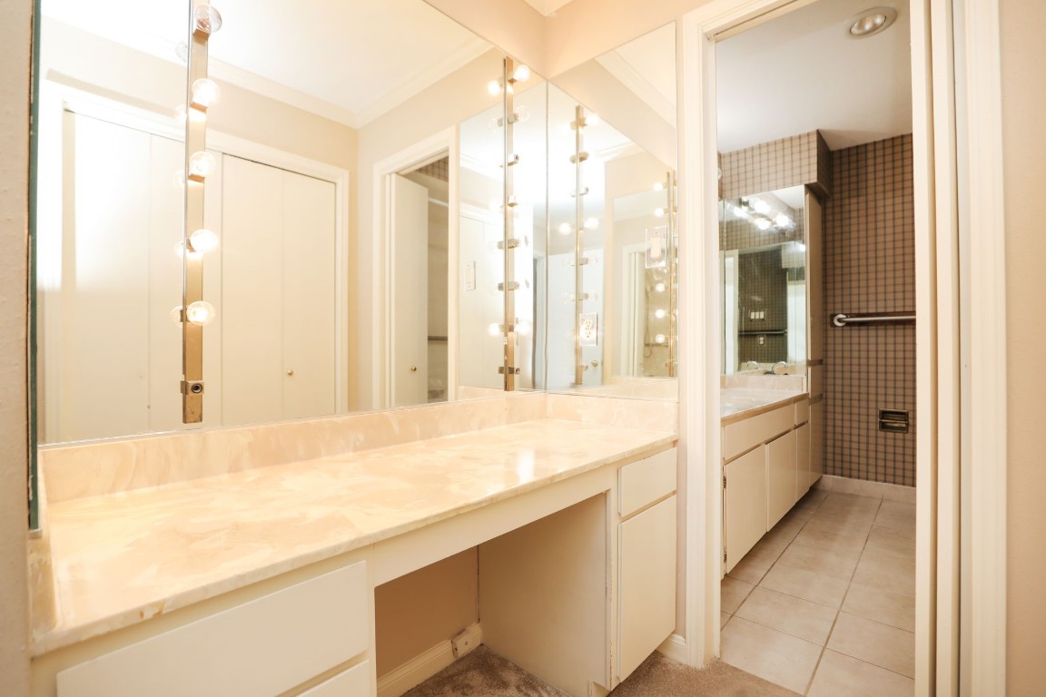 7499 Brompton Street, Unit 7499 Houston, TX 77025 - Photo 28 of 43 a bathroom with a granite countertop sink and a large mirror
