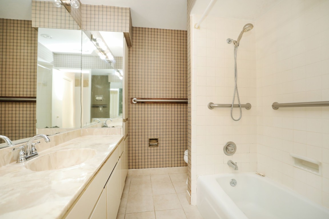 7499 Brompton Street, Unit 7499 Houston, TX 77025 - Photo 29 of 43 a bathroom with a tub sink and shower