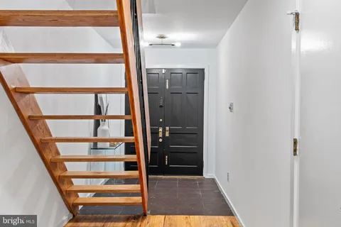 a kitchen with stainless steel appliances granite countertop a stove and a wooden floors