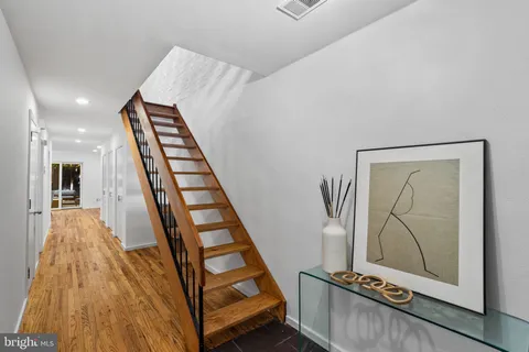 a kitchen with stainless steel appliances granite countertop a table chairs refrigerator and sink