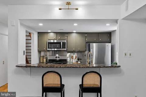 a view of swimming pool with outdoor seating and green space