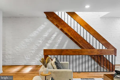 a bathroom with a granite countertop sink a toilet and mirror