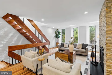 a front view of a house with a tree