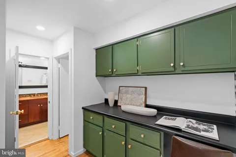 a living room with furniture a large window and wooden floor