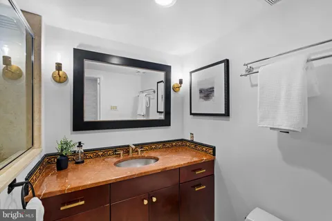 a bedroom with a bed a window and a chandelier