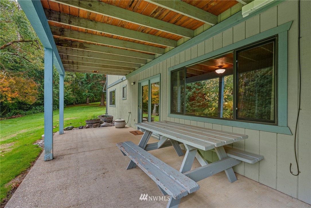 237 Frogner Road Chehalis, WA 98532 - Photo 23 of 37 a view of a patio with a table and chairs under an umbrella