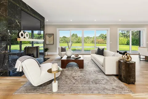 a living room with patio furniture and a large window