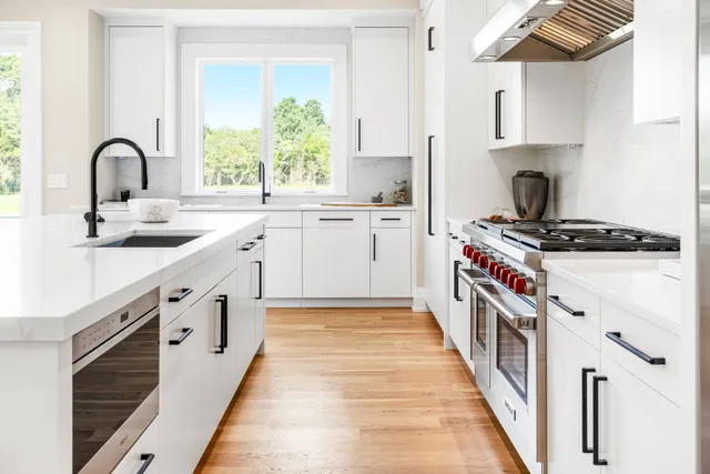 a kitchen with stainless steel appliances a sink and a stove