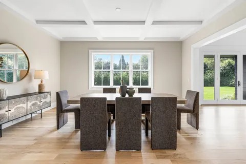 a kitchen with stainless steel appliances granite countertop table chairs sink and cabinets